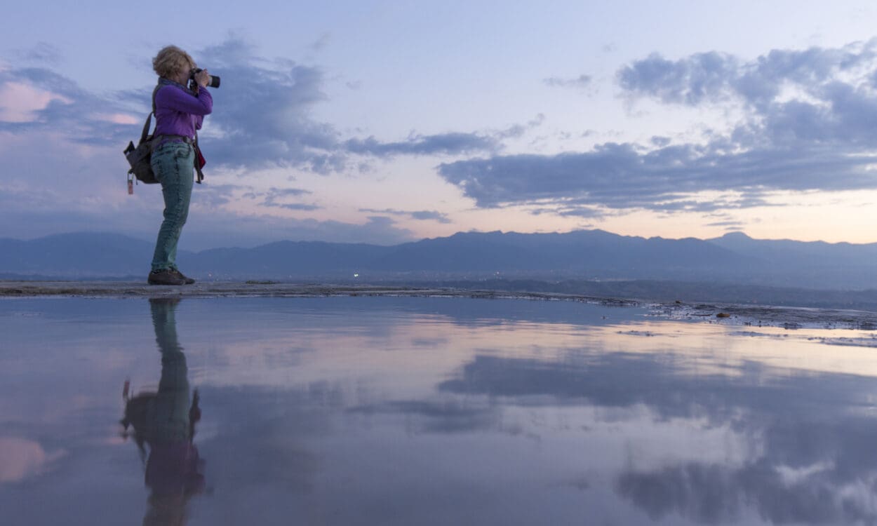 Photographer and their reflection at sunset