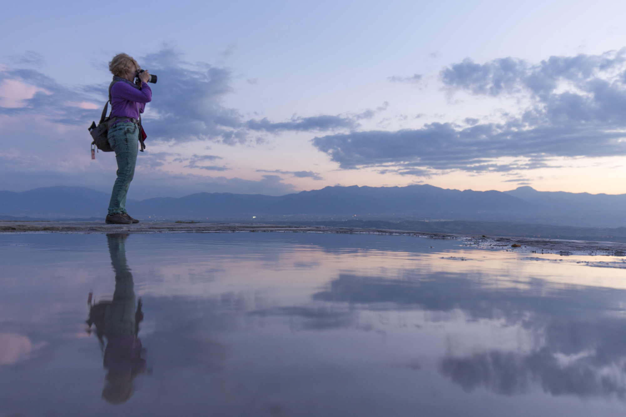 Photographer and their reflection at sunset