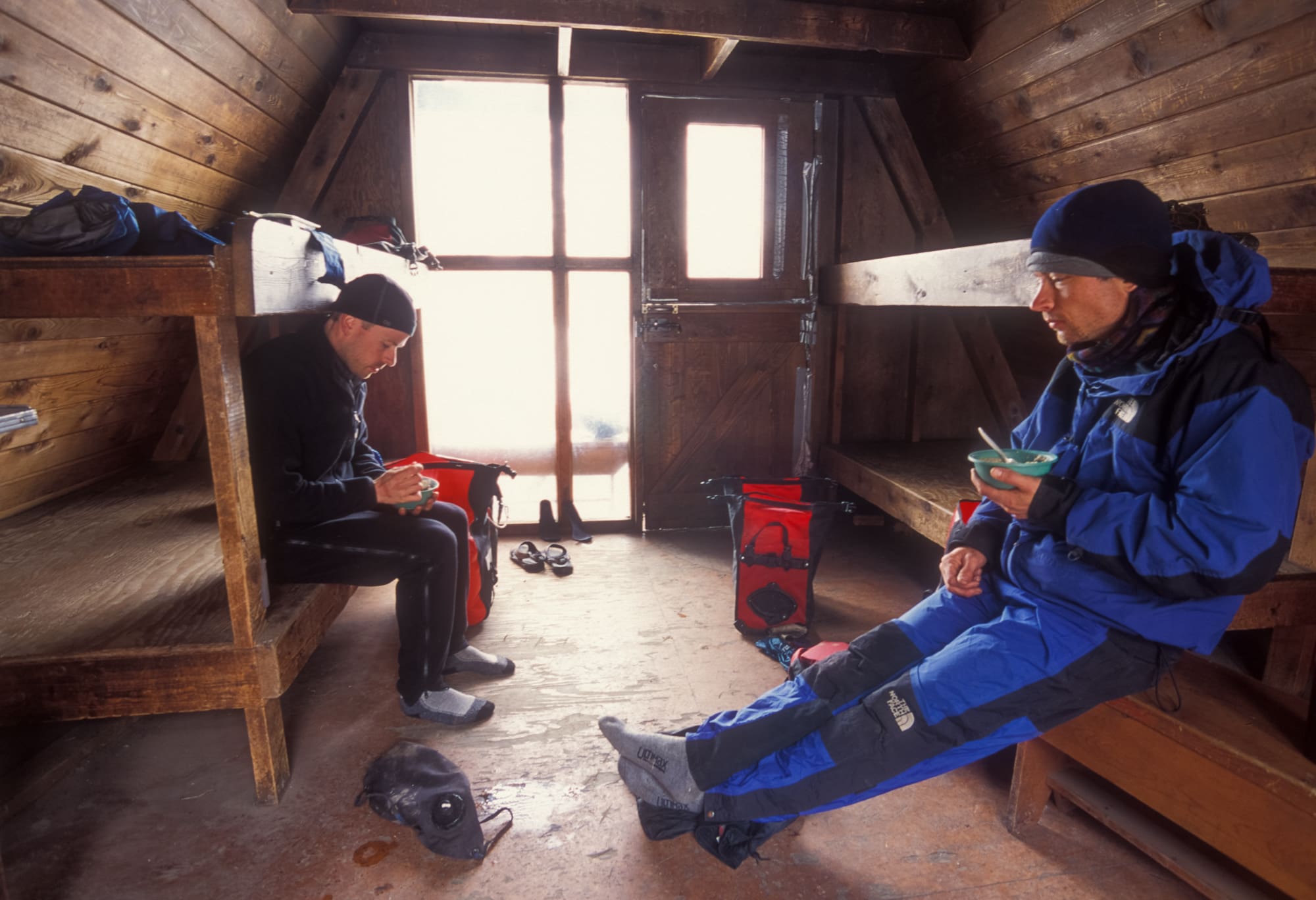 SHELTERED FROM THE WEATHER WE CONTEMPLATED OUR SITUATION OVER A HOT MEAL. JOHN (LEFT), TIM (RIGHT).