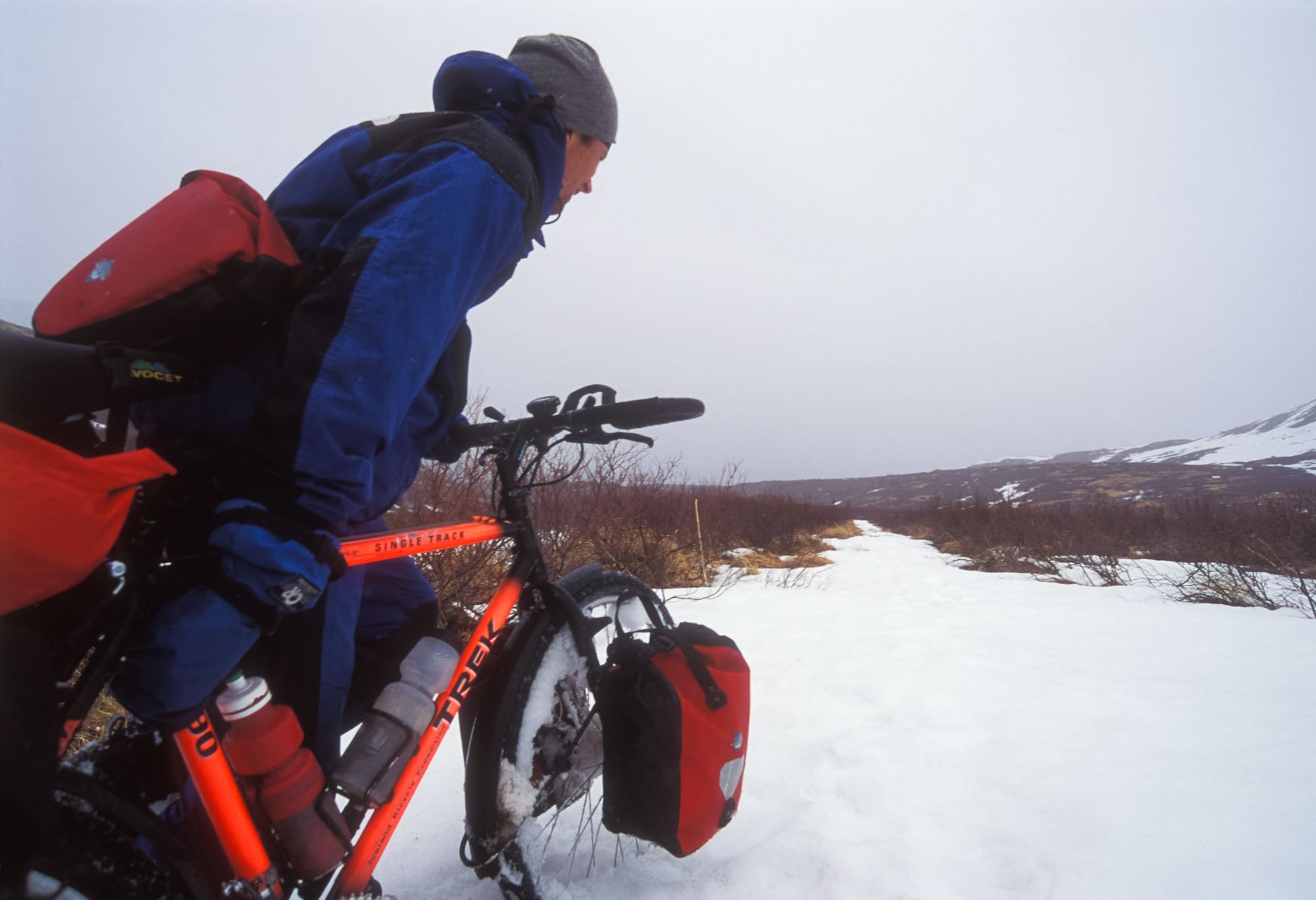 PUSHING THE BIKES UP TO THE PASS WAS MADE MORE DIFFICULT BY WET SNOW COLLECTING IN THE SPOKES.