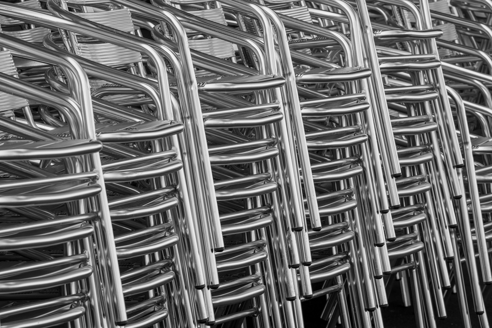 Stacked chairs forming a photographic pattern