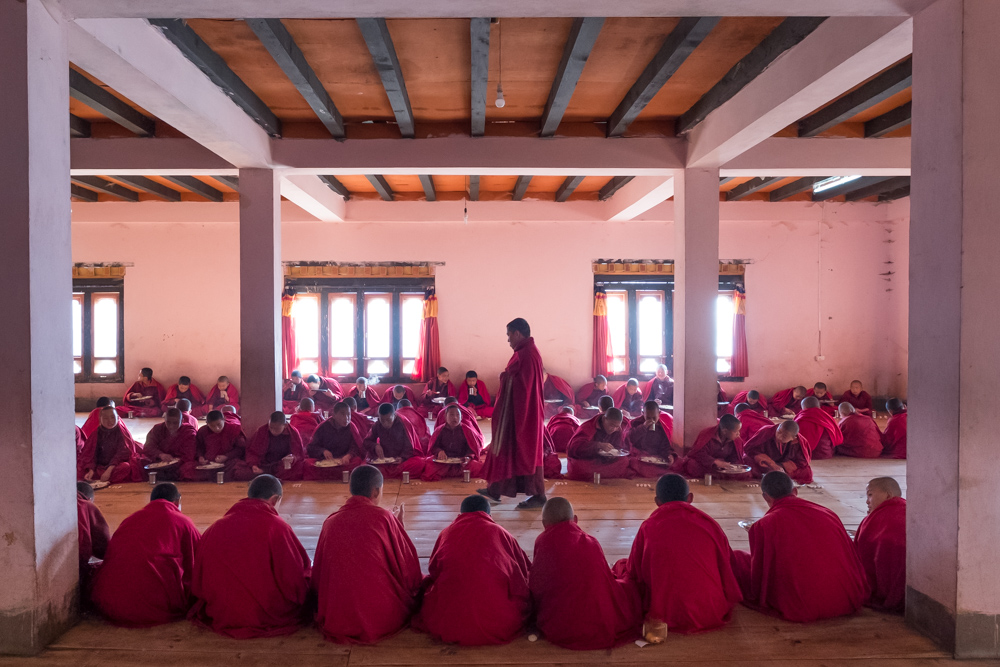 Image of many monks praying in a monastery